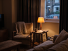 Quiet evening living room corner lit by a warm table lamp