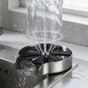 Glass pressed onto the rinser with jets of water spraying up inside it