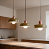 Three pendant lights hung at staggered heights above a kitchen island