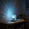 Ripple projector lit on a living room shelf beside books and a plant