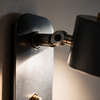 Close-up of the adjustable elbow joint and shade pivot on the wall lamp