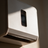 Close-up of the infrared sensor window and serrated cutting edge on the dispenser