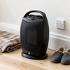 The heater beside a wall socket and skirting board, showing its compact size